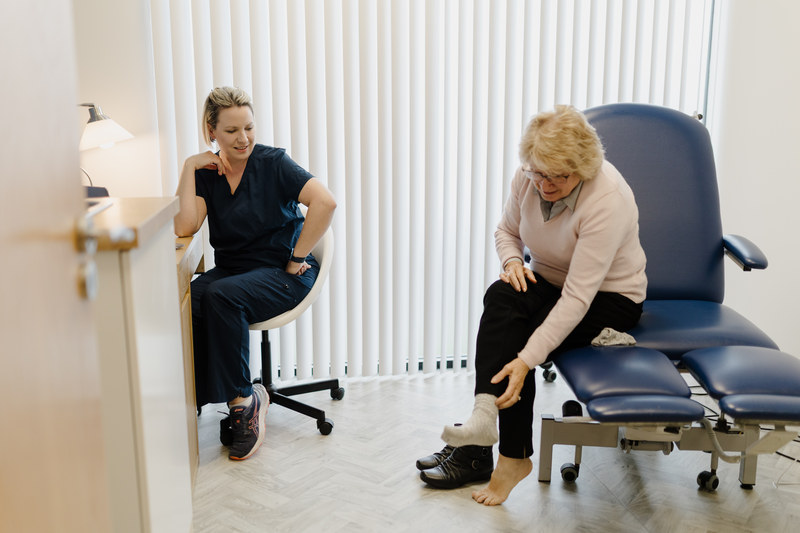 Podiatrist and client in practice